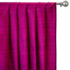 a pink curtain hanging on the side of a white wall with a metal pole in front of it