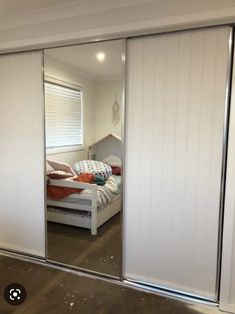 a bedroom with sliding doors and a bed