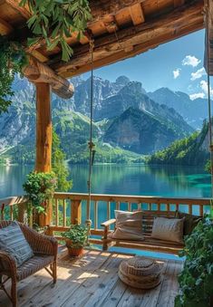 a wooden porch with two chairs and a swing hanging from it's side, overlooking a mountain lake