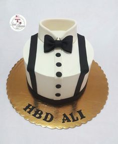 a white and black cake with a bow tie on it's top that says rrd ali