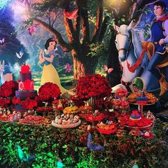 the beauty and the beast dessert table is decorated with red flowers, roses, and other foods