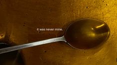 there is a spoon stuck in the side of a golden object that says it was never mine