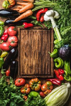 an assortment of fresh vegetables laid out on a wooden table top view - stock photo - images