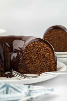 a chocolate bundt cake on a plate with a fork next to the bundt cake