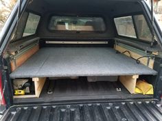 the back end of a pickup truck with its trunk open