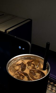 a pot filled with liquid sitting on top of a table