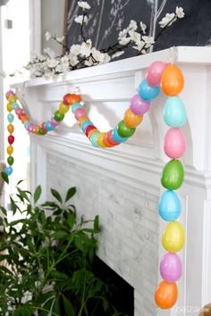 a decorated mantle with balloons and flowers on it in front of a white brick fireplace