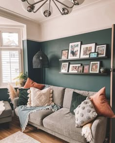 a living room filled with lots of furniture and pictures on the wall above it's couch