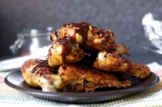 chicken wings piled on top of each other on a plate