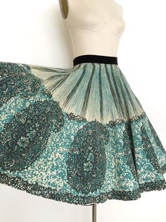 "vintage skirt  Era: 1950's Label: Bobbie Brooks Material: felted wool and velvet Closure: side metal zipper, button waist  Colour: blue, black, cream  Details: gorgeous large scale border block print of a paisley pattern, true circle skirt Fits like: xsmall Waist: 23\" Hips: free Length: 26\" Condition: There are a couple small holes on the inside which don't show through. Couple of tiny spots. Discolouration to the inside side seam. Repair behind the button waist closure. May need a dry clean to freshen it up.  Priced accordingly.  shop policy  * All items are a final sale. No returns, exchanges and, order cancellations are not accepted.  * Ruby Mae Rose is not responsible for lost or stolen parcel(s) and any duty, import, VAT charges that are determined by the receiving country. Ruby Ma 1950s Circle Skirt, Ruby Mae, 1950s Skirt, Bobbie Brooks, Wool Winter, 50s Vintage, Winter Skirt, Skirt Fits, Star Dress