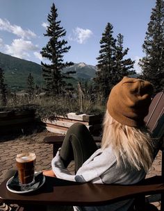 a person sitting on a bench with a cup of coffee