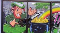 there is a large window decorated with images of st patrick's day and pot of gold coins