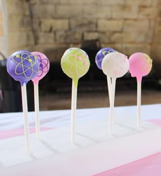 four lollipops sitting on top of a table