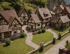 an aerial view of a small village with stone walkways and houses on the hillside