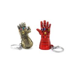 two key chains that are shaped like iron man and the other one has a glove on it