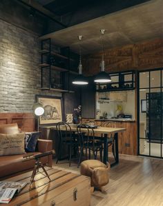 a living room filled with furniture next to a brick wall