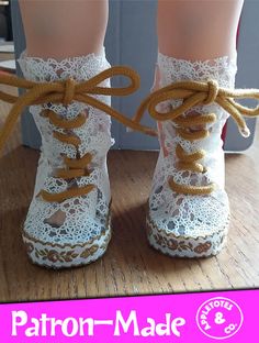 a doll's feet with lace on them and the bottom part of their boots