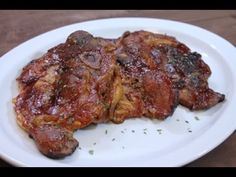 two pieces of meat sitting on top of a white plate