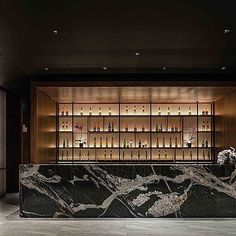 an elegant bar with marble counter tops and shelves