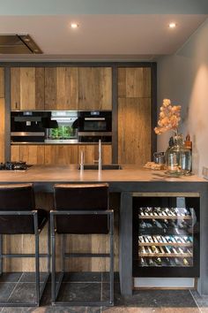 a modern kitchen with an island and wine cooler