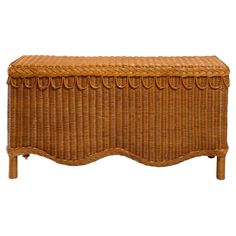 a brown wicker trunk with wooden legs