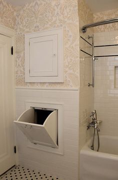 a bathroom with a sink, toilet and bathtub that has a door open to reveal a litter box