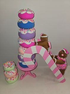 an assortment of donuts and other treats are arranged in the shape of a tower