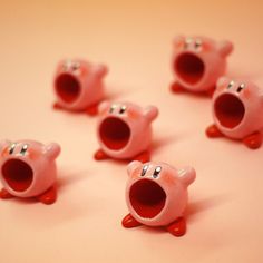 several pink plastic pig figurines sitting on top of a table