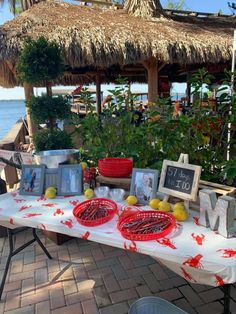 a table that has some food on it and is set up for an outdoor event