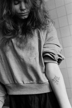 a woman with a tattoo on her arm