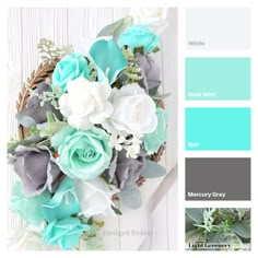 a bunch of flowers sitting on top of a white table next to some blue and green colors