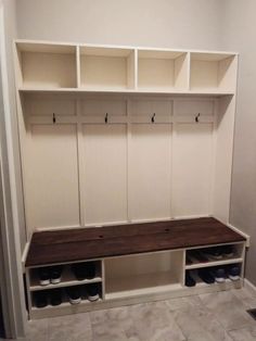 an empty bench in the middle of a walk - in closet with shoes on it