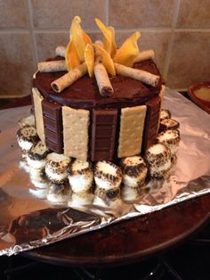 a chocolate cake with cookies and crackers on top