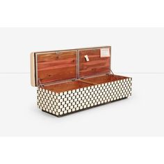 the trunk is made out of wood and has two compartments on each side, one with an open lid