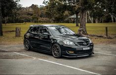 a black car parked in a parking lot