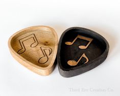 two wooden heart shaped boxes with musical notes carved into them