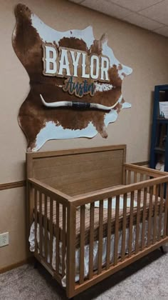 a baby crib in front of a wall with the word baylor on it