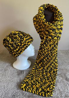 "Textured medium weight crochet winter scarf and/or hat in black and gold.  Designed for both men and women to compliment game day attire. Show off your team spirit in style! This unique tailgating accessory is made using the team colors of the New Orleans Saints, Pittsburgh Steelers Penguins and Pirates, Boston Bruins, Missouri University Tigers, University of Iowa Hawkeyes, and the Columbus Crew soccer team. This textured design features an eye catching teardrop stitch made with acrylic fibers. The scarf measures 60\" long 7.5\" wide and about 1/4\" thick.  The hat is 18\" in circumference and 10\" tall when flat. The stitches are flexible and will stretch to fit head sizes up to 21\". Hand washing and air drying is recommended and will keep your hand made item long lasting.  Item can be Missouri University, Crochet Winter Scarf, Spirit Game, Columbus Crew, Loom Knitting Projects, University Of Iowa, Crochet Winter, Iowa Hawkeyes, Tailgate Accessories