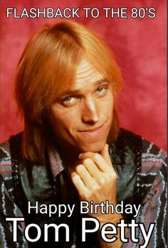 a man with long hair wearing a leather jacket and looking at the camera while leaning on his hand