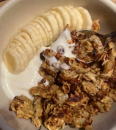 a bowl filled with granola, bananas and yogurt