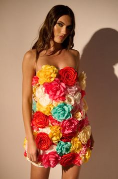 Bouquet all day. The AKIRA Label Flower Power Mini Dress is a top tier closet addition that features a slightly stretchy double lined mesh fabrication, a strapless neckline with inner elastic trim, a flattering bodycon design, a mini length hem, soft polyester inner lining, and a tonal back zipper closure. Complete with colorful multi-fabric assorted floral appliques scattered throughout, some with ornate clustered pearl-bead centers. Style with satin mules and a floral-silhouette handbag for a darling warm-weather ensemble.  Due to dye and cut variations, each garment's pattern will differ slightly than from one shown.  - Shell: 95% Polyester 5% Spandex- Some Stretch- Imported(all measurements are approximate from size small)- 27.5” Chest to Hem - Model is 5’9”Product ID: 387685 Closet Addition, Garment Pattern, Flower Diy, Cute Crop Tops, Diy Dress, Floral Applique, Hottest Trends, Top Tier, Flower Power