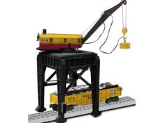 a crane is attached to the back of a train car on a platform with other equipment