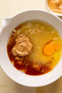 a white bowl filled with soup and peanut butter