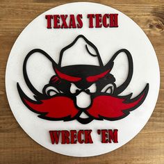 a round sign that says, texas tech wreck'em on the side of a wooden wall