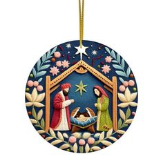 a christmas ornament with a nativity scene in the center and stars on top