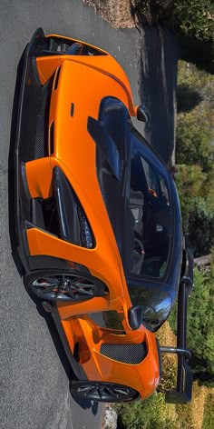 an orange sports car is seen from above