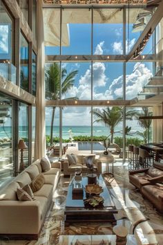 a living room filled with lots of furniture next to a large window covered in windows