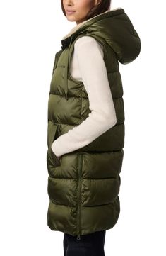 Getting cozy for the cooler seasons is easy in this puffer vest boasting a hood and longline design for warm coverage. Fluffy faux shearling lines the inside for soft touch and stylish texture. Front zip closure with snap storm placket Drawstring hood Front welt pockets Side zip vents Lined, with synthetic fill 100% recycled polyester with 100% polyester faux-shearling contrast Machine wash, tumble dry Made in China Luxury Outdoor Puffer Vest, Light Green Puffer Vest, Fitted Outdoor Puffer Vest, Green Hooded Puffer Jacket With Double-lined Hood, Green Long Sleeve Puffer Jacket With Double-lined Hood, Womens Puffer Vest, Long Puffer, Puffer Vest, Getting Cozy