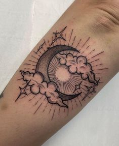 a black and white tattoo on the arm of a person with clouds and sun in the sky