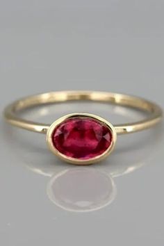 Natural Ruby gold ring, July's Birthstone Ring, Solid 14k Gold Ruby Engagement Ring, Gemstone Ring. A handmade solid 14k gold ring set with a natural rubystone.This ring is a dazzling, solitaire ruby ring. The ruby gem isset in an open bezel exposing the ruby to morelight and increasing it's intensity.The ring was designed with the bezel sitting on top of the ring allowing you to wear it on it's own or to stack it with other rings. 14k Gold Ruby Ring With Round Band, Minimalist 14k Gold Red Ruby Ring, Yellow Gold Solitaire Ruby Rings, Yellow Gold Solitaire Ring With Ruby, Ruby Ring With Bezel Setting, Round Cut, Fine Jewelry Yellow Gold Solitaire Ruby Ring, Round Ruby Birthstone Ring Stamped 14k, Bezel-set Round Cut Ruby Ring, Yellow Gold Ruby Rings With Bezel Setting